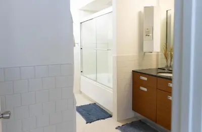 a bathroom with a tub and a sink and a shower at Chic urban loft steps from dining and shopping in Los Angeles