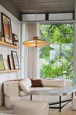 a living room with a couch and a large window at New Listing Modern Hollywood Hills Sanctuary by Colby & Conrad in Los Angeles