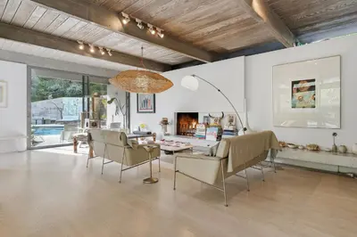 a living room with chairs and a table and a fireplace at New Listing Modern Hollywood Hills Sanctuary by Colby & Conrad in Los Angeles