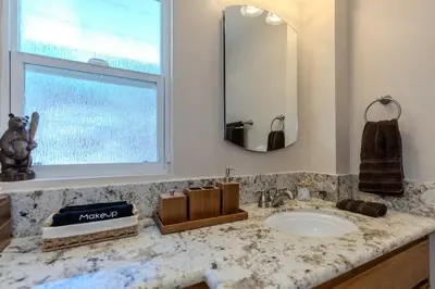 a bathroom counter with a sink and a mirror at Luxury Lakefront Retreat,HotTub,EV Charge,Fire Pit in Big Bear Lake