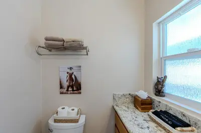 a bathroom with a toilet and a window at Luxury Lakefront Retreat,HotTub,EV Charge,Fire Pit in Big Bear Lake