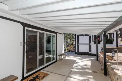 a white house with a white ceiling and a patio at Luxury Lakefront Retreat,HotTub,EV Charge,Fire Pit in Big Bear Lake