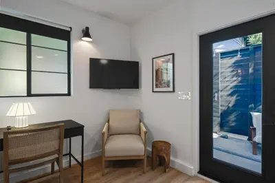a room with a desk and a tv and a chair at Modern Luxe Studio in East Los Angeles in Los Angeles