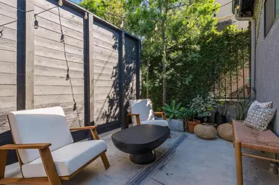 a patio with two chairs and a table and a bench at Modern Luxe Studio in East Los Angeles in Los Angeles