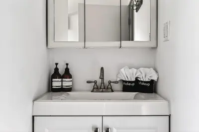 a white kitchen sink with bottles of wine at Elegant 3-bedroom home Retreat in East Los Angeles in Los Angeles