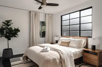 a bedroom with a bed and a large window at Elegant 3-bedroom home Retreat in East Los Angeles in Los Angeles
