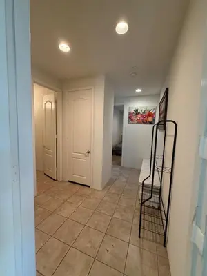a hallway with a table and a painting on the wall at Cozy 2-Bedroom Home in Eastvale in Corona