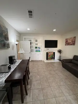 a living room with a couch and a television at Cozy 2-Bedroom Home in Eastvale in Corona