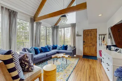 a living room with a couch and a table at Mountain Playhouse in Lake Arrowhead