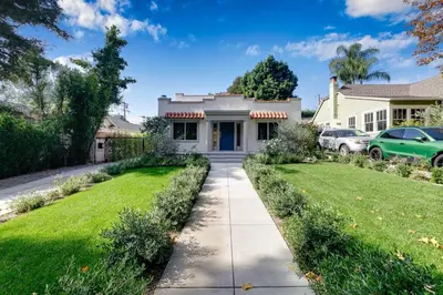 a house with a driveway and grass at Chic WeHo Retreat near Sunset Blvd in Los Angeles