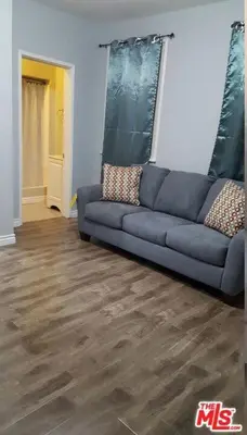 a blue couch in a living room with wooden floors at Cozy Studio Apt Studio City Unit 5 in Los Angeles