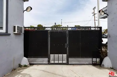 a large black gate in the side of a house at Cozy Studio Apt Studio City Unit 5 in Los Angeles