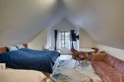 a bedroom with a bed and a couch and a table at Outdoor Oasis in Pine Mountain Club! Cabin Getaway in Pine Mountain Club