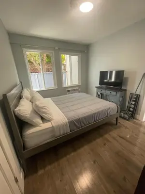 a bedroom with a bed and a flat screen tv at Cozy 1 Bedroom Tarantino Unit Studio City in Los Angeles