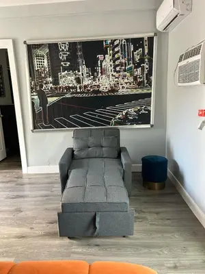 a living room with a couch and a painting on the wall at Cozy 1 Bedroom Tarantino Unit Studio City in Los Angeles