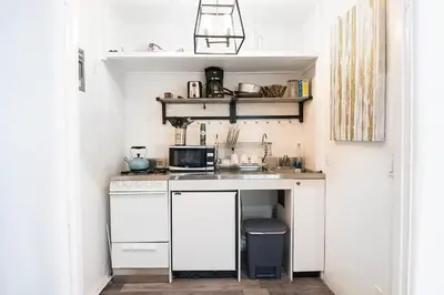 a small kitchen with a sink and a microwave at Cozy Studio by Rodeo Drive in Los Angeles