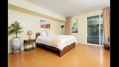 a bedroom with a bed and a large window at Admiralty 2BD Luxe Retreat with FREE PARKING in Los Angeles