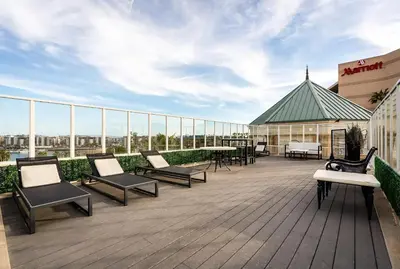 a rooftop deck with chairs and tables on a building at Admiralty 2BD Luxe Retreat with FREE PARKING in Los Angeles