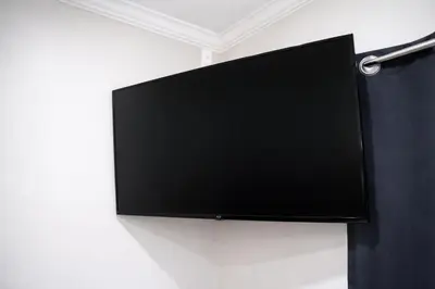a flat screen tv hanging on a wall at Carlton Motel in Los Angeles