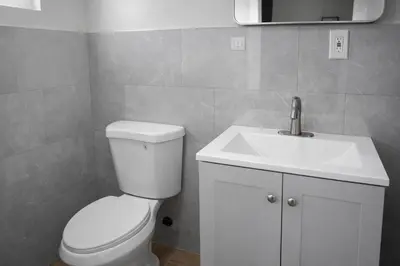 a bathroom with a white toilet and a sink at Carlton Motel in Los Angeles