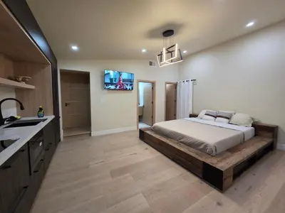 a bedroom with a bed and a tv on the wall at Private Studio City Suite Walk to Universal-15 min in Los Angeles