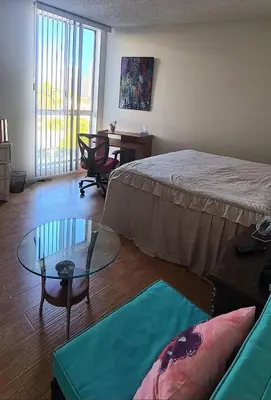 a bedroom with a bed and a glass table at Fara UCLA in Los Angeles