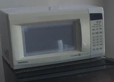 a white microwave oven sitting on top of a shelf at Fara UCLA in Los Angeles