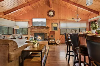 a living room with a couch and a fireplace at Pinecone Den in Big Bear Lake