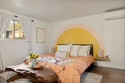 a bedroom with a large bed with an archway at The Willow Cabin in Big Bear Lake