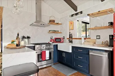 a kitchen with blue cabinets and a stove top oven at The Willow Cabin in Big Bear Lake