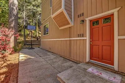 a red door on the side of a house at Arrowhead Cabin Near Lake and Village in Lake Arrowhead