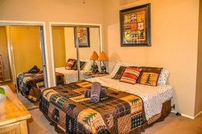 a bedroom with two beds and a mirror at Arrowhead Cabin Near Lake and Village in Lake Arrowhead