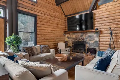 a living room with couches and a fireplace at Vista Lodge! 20 min to Silverwood Lake in Cedarpines Park