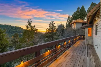 a balcony of a house with a view of the mountains at Vista Lodge! 20 min to Silverwood Lake in Cedarpines Park