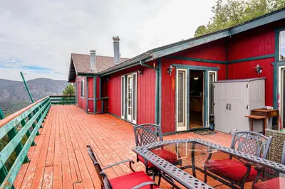 a red house with two chairs on a deck at Private Sauna and Mtn-View Deck! Kern County Home in Pine Mountain Club