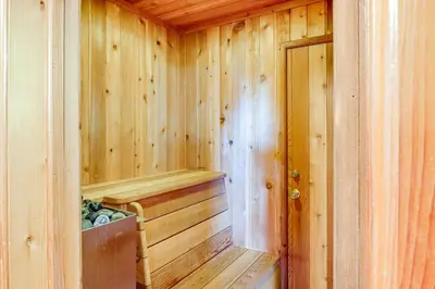 a wooden sauna with a wooden door in a cabin at Private Sauna and Mtn-View Deck! Kern County Home in Pine Mountain Club