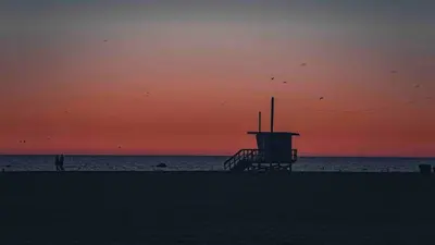 a lifeguard tower on the beach at sunset at Sweet 2 bedrooms home by the beach city in Los Angeles