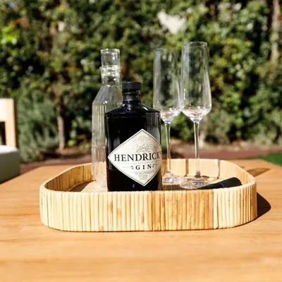 a bottle of wine and glasses on a wooden table at Modern Mid-Wilshire Escape Prime Spot in Los Angeles