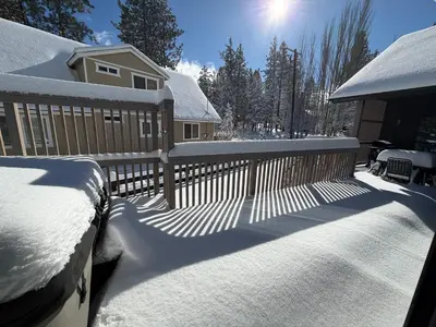 a fence covered in snow in front of a house at Bearadise, LuxuryNew Build, Central, Hot Tub, EV ,Games in Big Bear Lake
