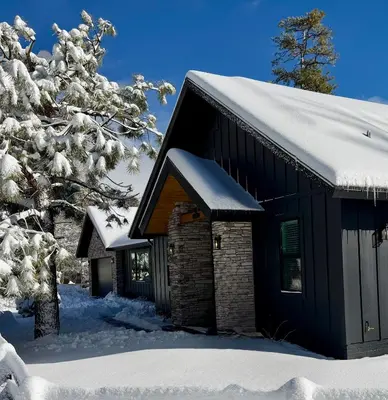 a black house with snow on the roof at Bearadise, LuxuryNew Build, Central, Hot Tub, EV ,Games in Big Bear Lake