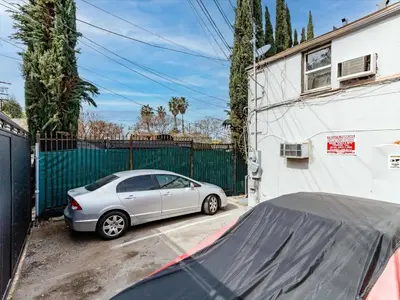 a silver car parked in front of a fence at Cozy Studio, Studio City Unit 3 in Los Angeles