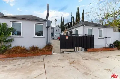 a white house with a gate and a driveway at Cozy Studio, Studio City Unit 3 in Los Angeles