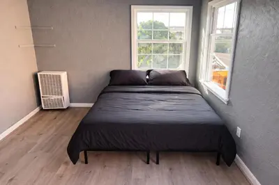 a bed in a small room with a window at Hoover Homes for the Soul in Los Angeles