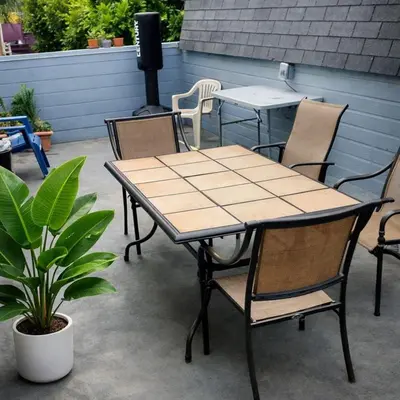 a table and chairs and a table and a plant at Robertson Homes of Love in Los Angeles