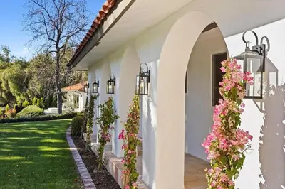 a white house with flowers on the side of it at Lavender House - Serene Ojai Retreat, Pool, Orchard in Ojai