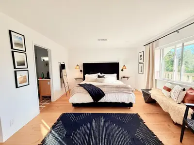 a bedroom with a large bed and a couch at Lavender House - Serene Ojai Retreat, Pool, Orchard in Ojai