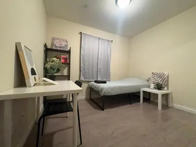 a room with a bed and a desk with a computer at Blue Urban Stay LA in Los Angeles