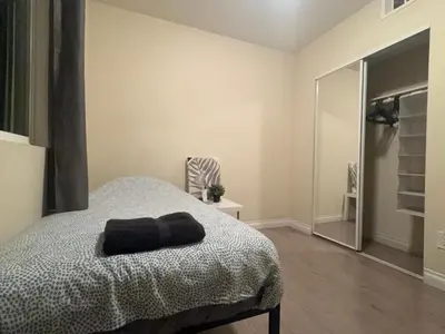 a bedroom with a bed with a black towel on it at Blue Urban Stay LA in Los Angeles