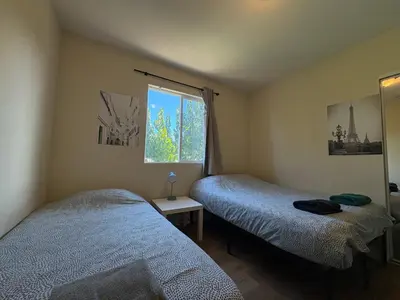 a bedroom with two beds and a window at Blue Urban Stay LA in Los Angeles