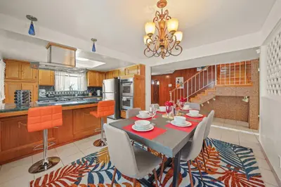 a dining room with a table and chairs in a kitchen at Spacious 5 Bedroom Home Near Disneyland & Knotts with Jacuzzi Spa in Norwalk